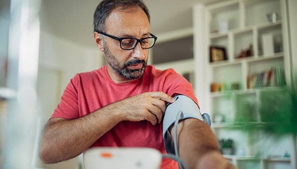 Man measuring his blood pressure for healthy ageing