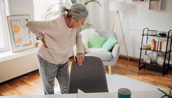 Elderly lady suffering from chronic back pain