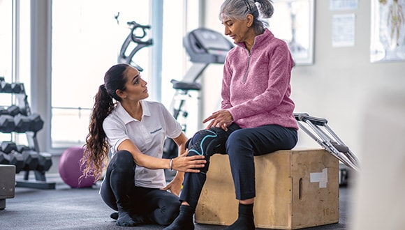 A woman getting her joint pain looked at by the physio