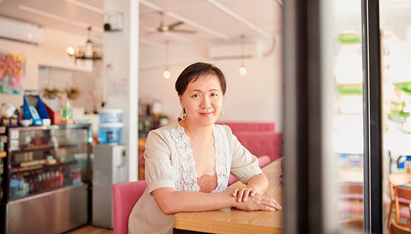 Female business owner sitting at table 