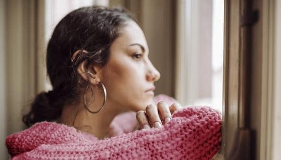 woman looking out a window