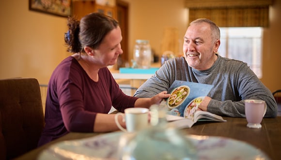 Guy sitting at a table with partner