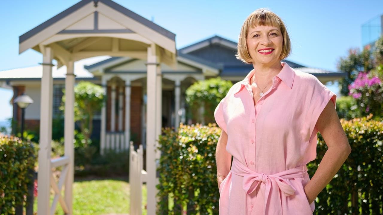 Jocelyn standing in front of her house