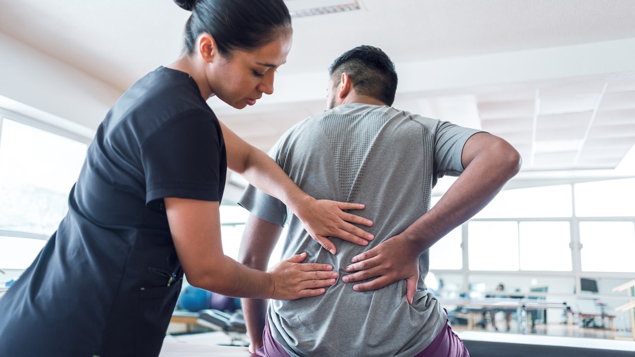 Physio addressing back pain