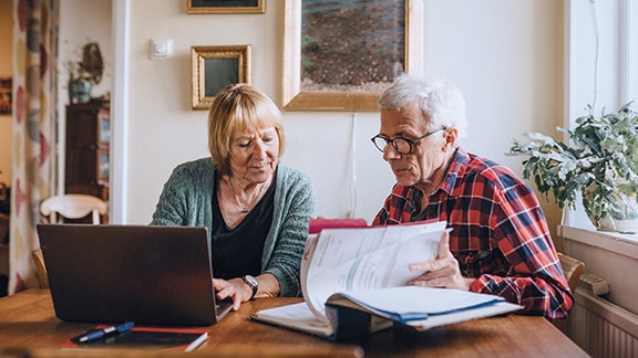 Older couple discussing documents at home